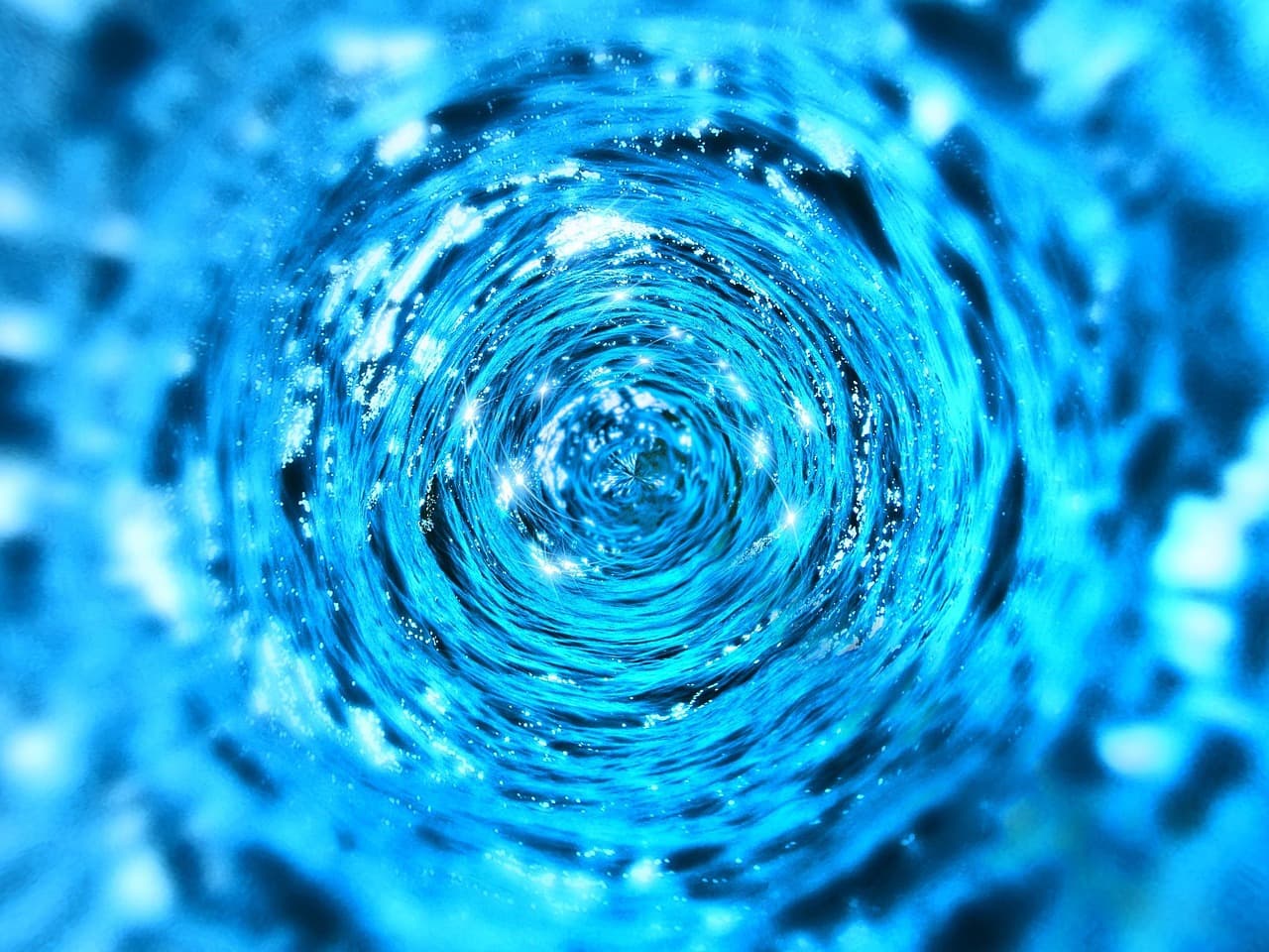 Deep blue water spiralling around a central point