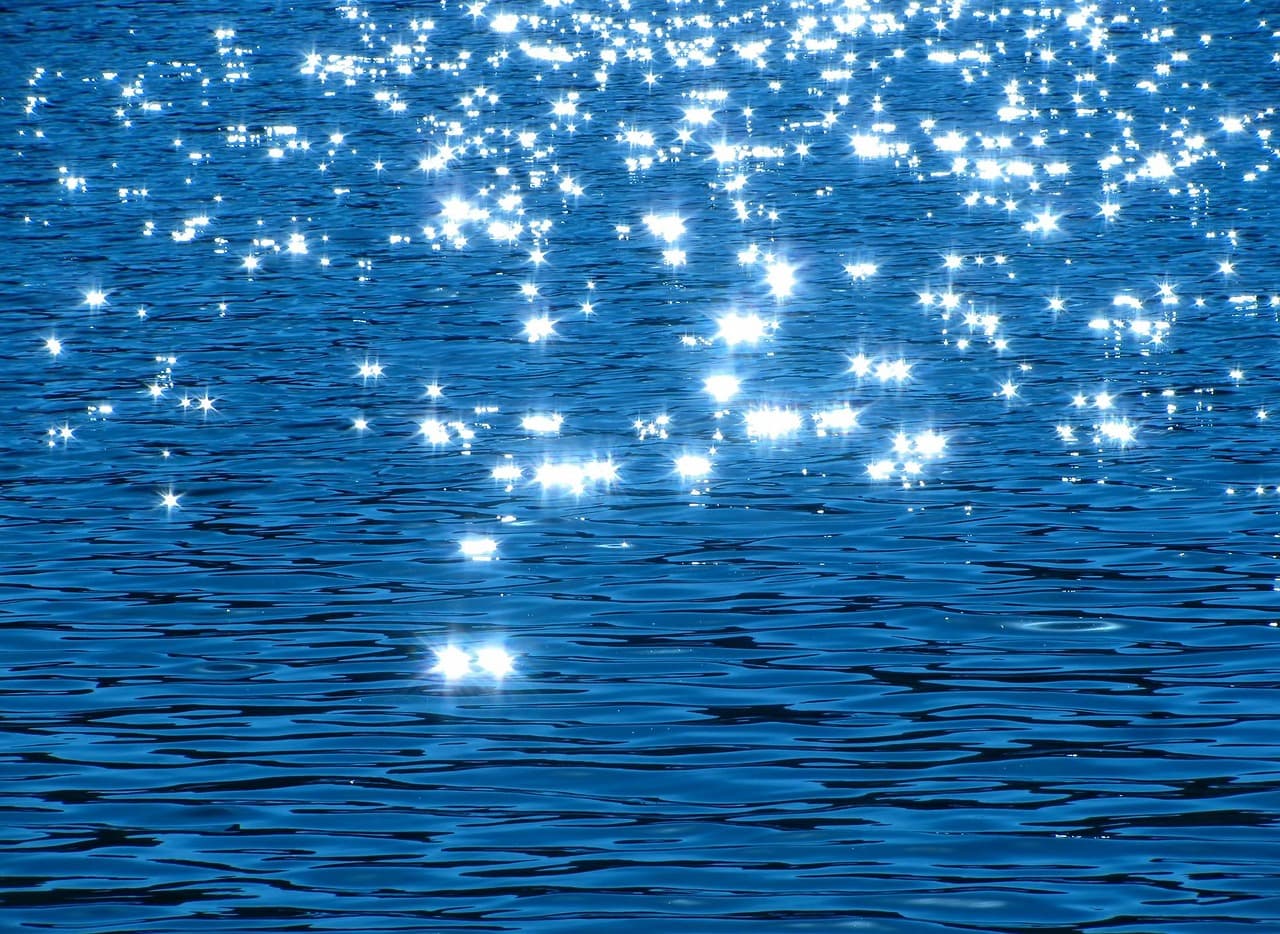 Points of light scattered across dark rippling water