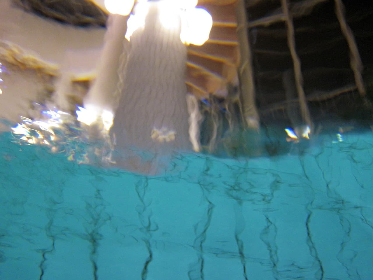 The waterline of an indoor spa seen from just below the surface